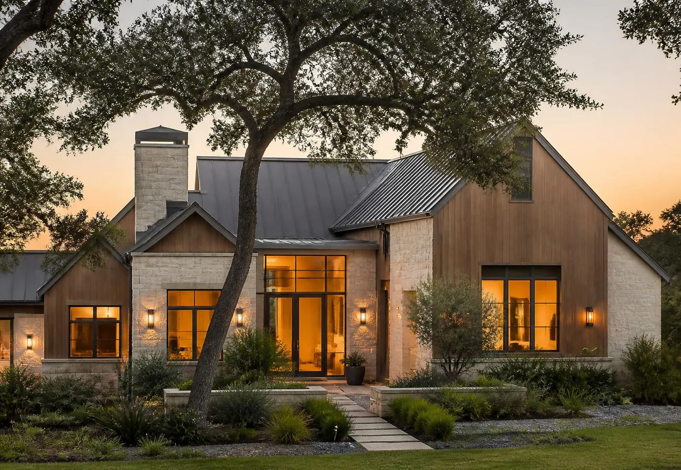Custom stone and cedar home built in the Texas hill country at golden hour